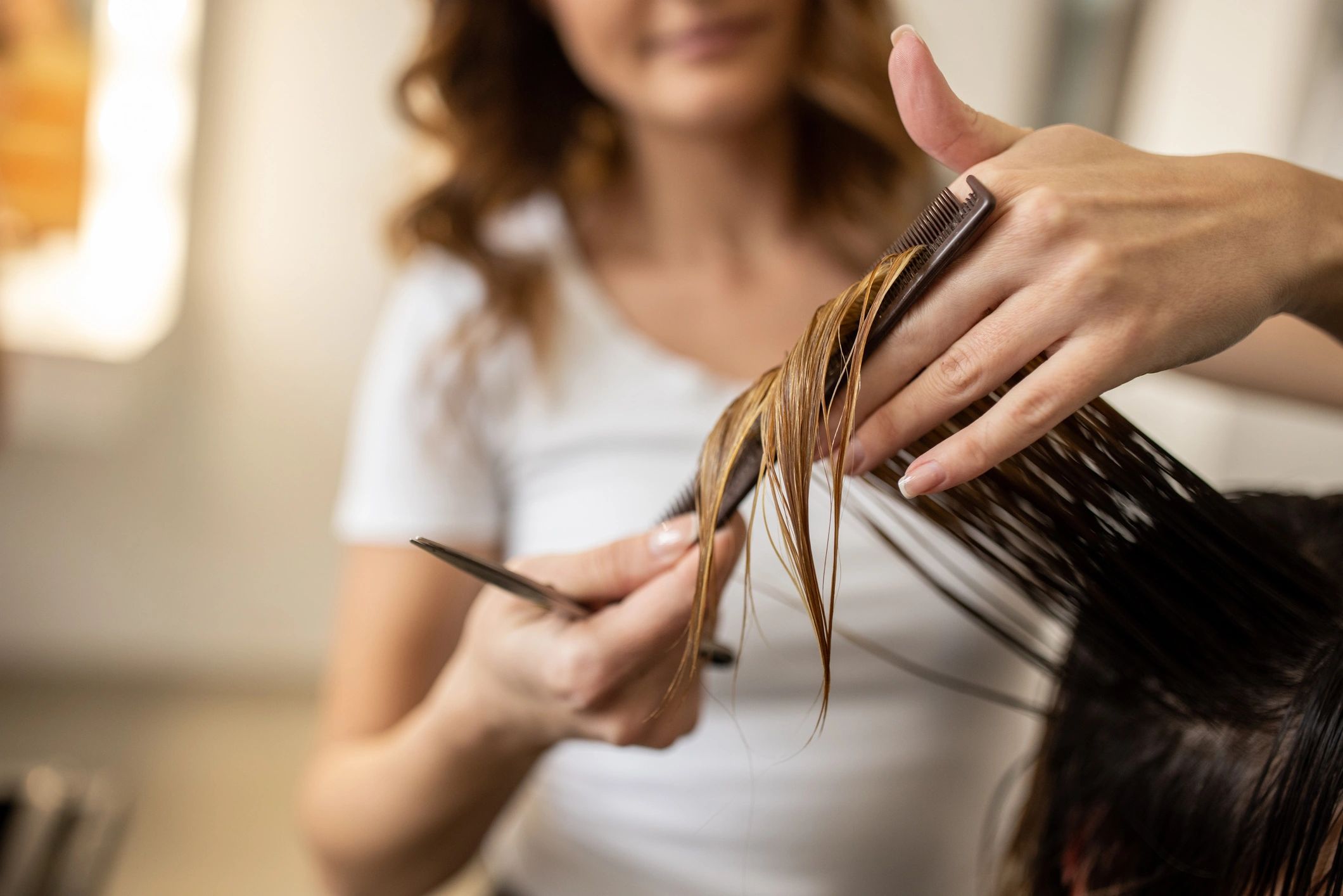 Stylist cutting a client’s hair during a salon appointment