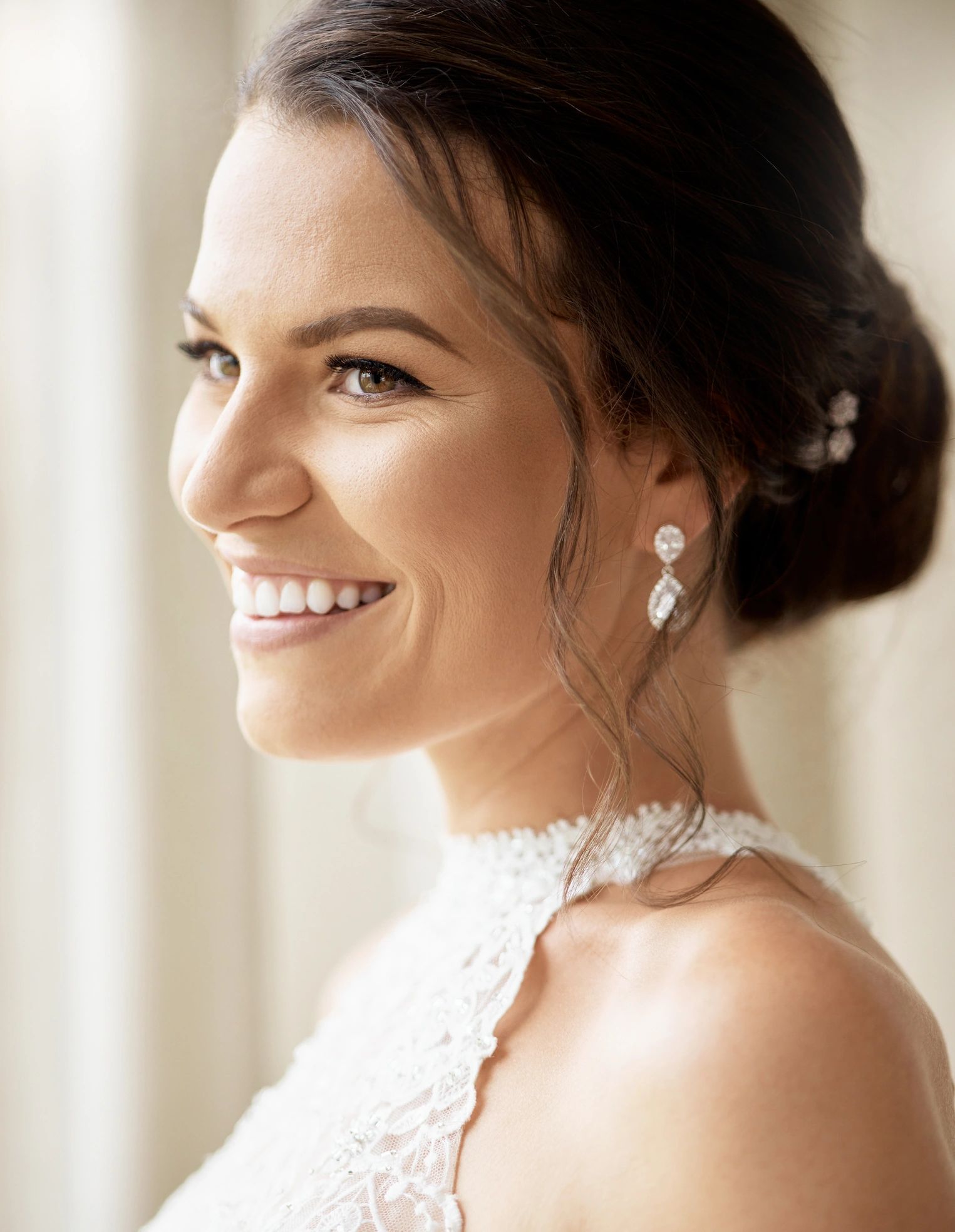 Bride with elegant updo hairstyle and soft glam makeup