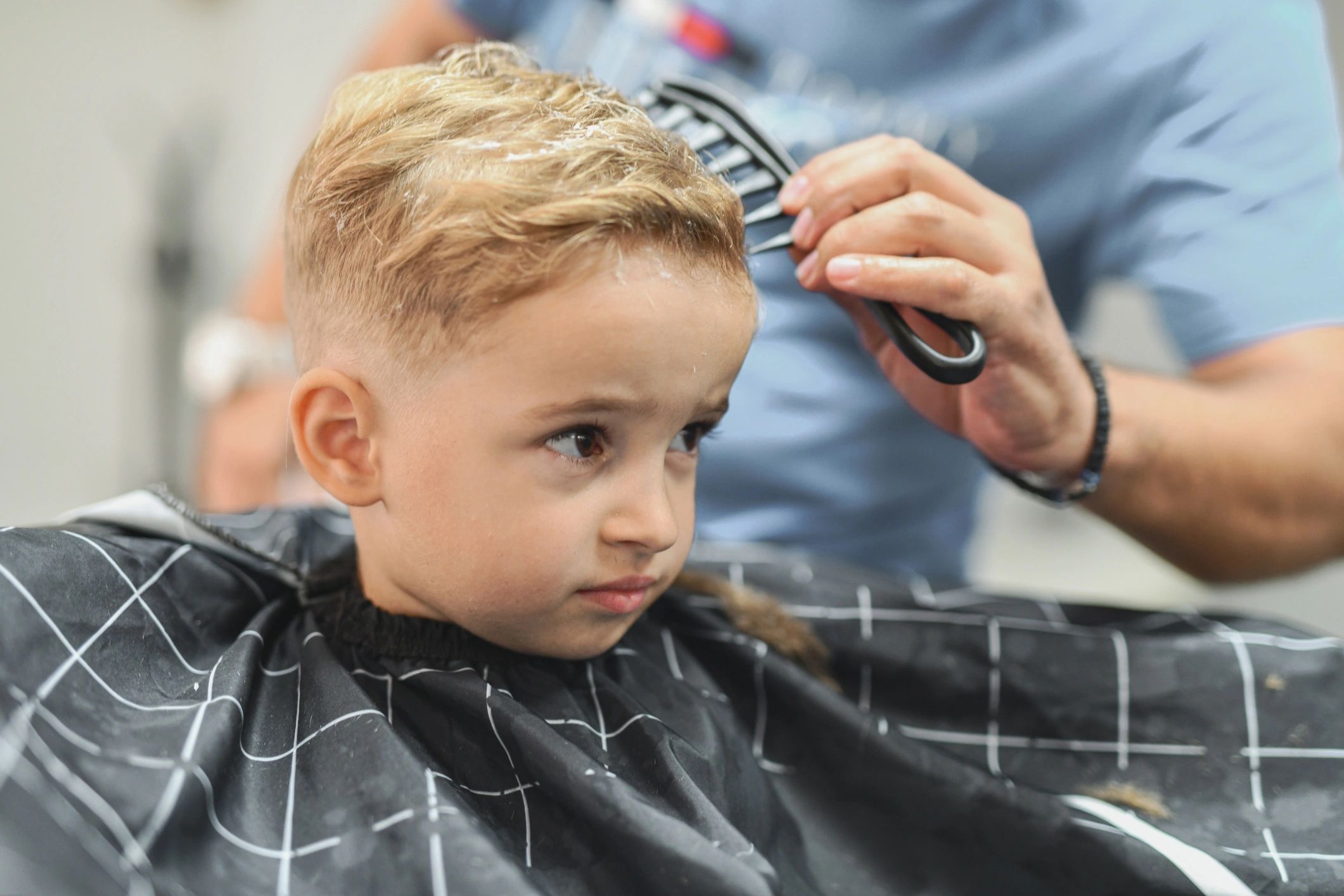 Stylist finishing a haircut in a salon